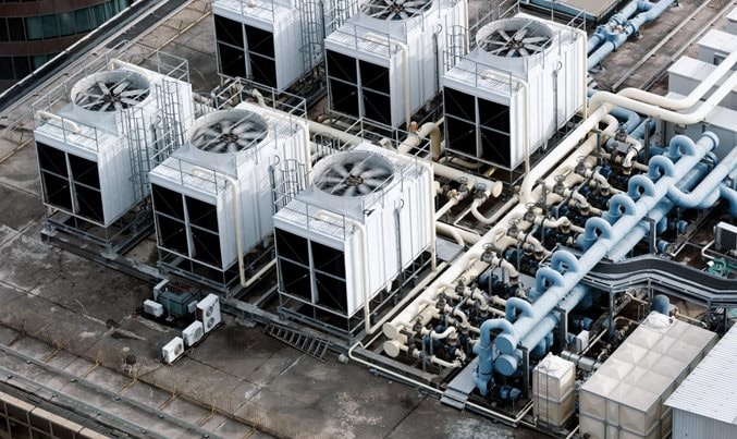 ndustrial HVAC cooling units and ventilation fans on a high-rise building rooftop